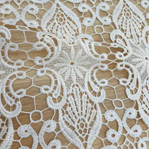 High-definition close-up showing the intricate white 3D floral lace embroidery detail