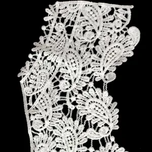 Detailed macro view of delicate white milk silk water-soluble embroidered lace collar
