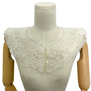 Close-up detail of a white milk silk embroidered lace false collar with elegant pearl buttons
