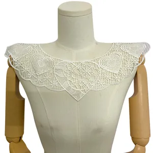 Detailed view of white polyester embroidered lace fake collar with heart patterns on mannequin