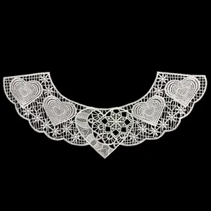 Detailed view of white polyester embroidered lace collar with heart patterns on black background
