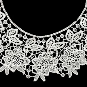 Detailed macro view of intricate white milk silk floral embroidered lace fake collar piece