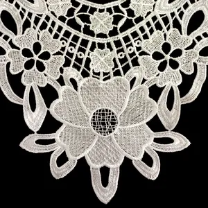 Macro detail of white floral embroidered polyester water-soluble lace collar