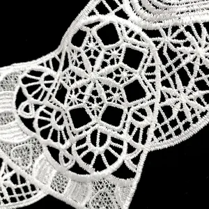 Close-up detail of white polyester embroidered lace collar with hollow floral patterns