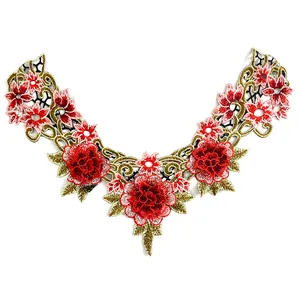 Detailed embroidery of red floral lace collar with intricate gold leaf pattern