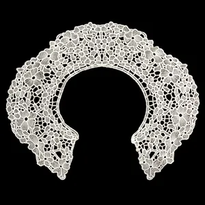 Detail view of white milk silk embroidered lace faux collar with pearl buttons.