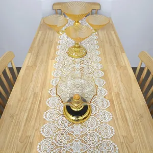 Elegant white lace hollow table runner with 3D floral embroidery for dining decor.
