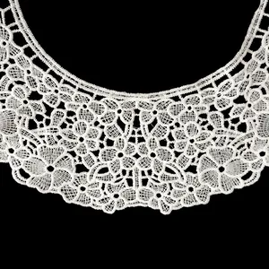 Detailed close-up of white milk silk embroidered floral lace collar with hollow patterns