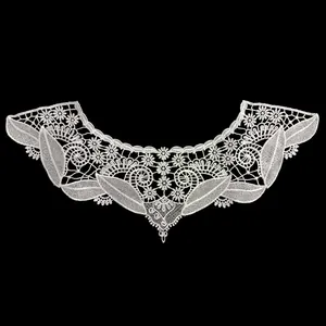 Macro view of white embroidery lace fake collar with intricate hollow floral design
