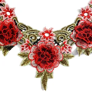Close-up of heavy work embroidered lace collar with red floral ethnic patterns.