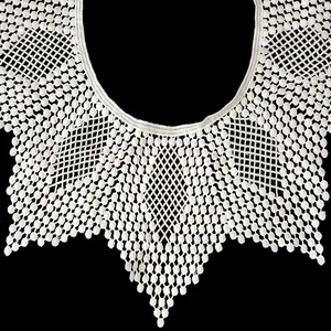 Macro detail showing intricate white milk silk embroidery lace on a detachable doll collar.