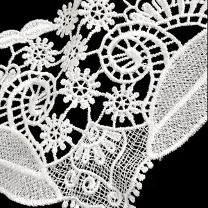 Close-up of white polyester embroidery lace trim with intricate floral hollow pattern