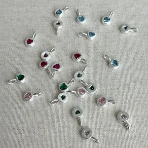 Detailed view of assorted S925 silver heart pendants with colorful heart-cut gemstones.