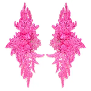 Detailed view of a pair of vibrant pink symmetrical lace embroidery floral patches for DIY