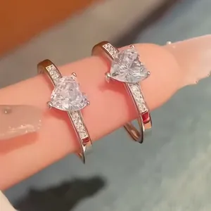 Close-up of s925 silver heart rings with adjustable bands and sparkling gems