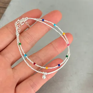 Close-up of a double-layer s925 silver bracelet with colorful beads and a ball charm.