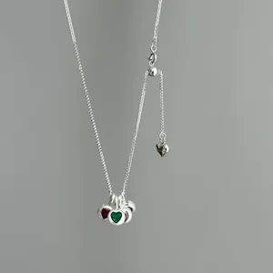 Close-up of S925 silver necklace featuring multiple colorful heart-shaped crystal pendants