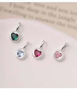 Detailed view of colorful S925 silver heart pendants with textured finish and vibrant stones