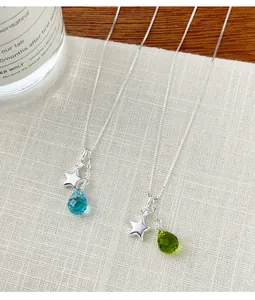 Close-up of s925 silver necklace featuring star charms and colorful glass water-drop pendants