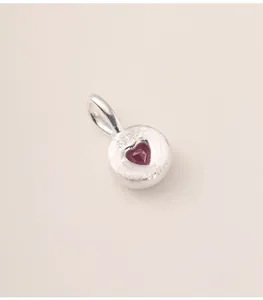 Detailed macro view of S925 sterling silver heart pendant with red crystal stone
