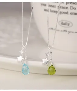 Detailed macro view of S925 silver necklaces with star and faceted teardrop glass.
