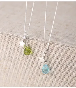 Close-up of s925 silver necklaces with star charms and faceted glass teardrop pendants