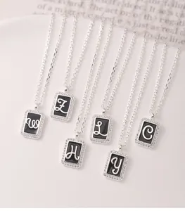 Detailed view of s925 silver square necklaces with elegant cursive letters and pavé crystals