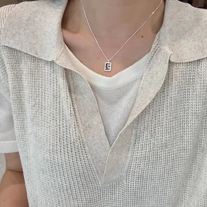 Detailed view of an s925 silver square pendant necklace featuring letter G with crystals