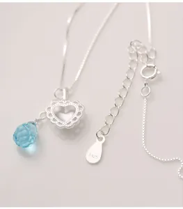 Close-up detail of S925 silver heart necklace with blue water-drop gemstone