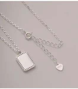Close-up detail of S925 sterling silver necklace featuring a minimalist rectangular tag pendant