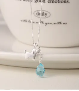 Close-up of S925 silver necklace featuring a cute dog pendant and blue teardrop stone