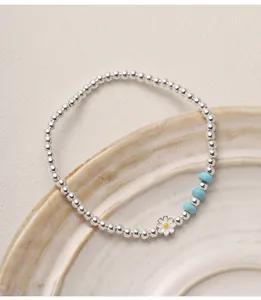Vue rapprochée du bracelet marguerite en argent massif avec des perles de turquoise