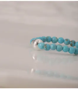 Macro view of turquoise beaded ring with S925 sterling silver hallmark and bead texture