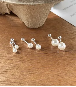 Close-up detail of 925 sterling silver screw-back faux pearl stud earrings in three sizes
