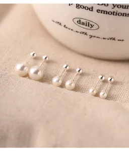Close-up of three pairs of 925 sterling silver pearl stud earrings with screw back closures.