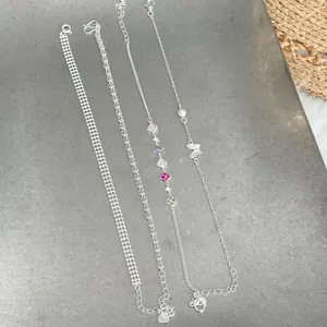Set of four s925 silver chain bracelets with delicate floral and butterfly details