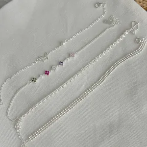 Detailed view of S925 silver bracelet set featuring butterfly and clover charms