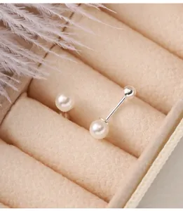 Close-up of 925 sterling silver stud earrings featuring white pearls and screw-back closure.