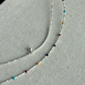 Detailed macro view of S925 sterling silver bracelet with vibrant colorful enamel beads