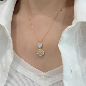Close-up detail of a gold-plated s925 silver necklace with oval Hetian jade pendant.