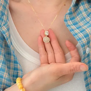 Detail of sterling silver necklace with natural Hetian jade and cubic zirconia pendants
