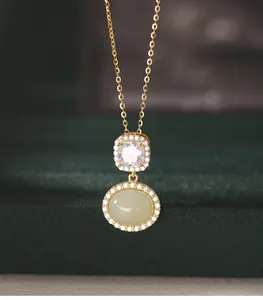 Close-up detail of s925 silver necklace featuring an oval Hetian jade and diamond pendant.