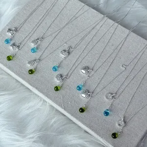 Detailed view of S925 silver necklaces with heart and apple pendants and crystal drops