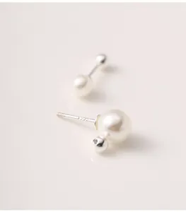 Macro detail of S925 sterling silver screw back earrings with elegant faux pearls