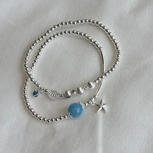 Detailed view of S925 silver beaded bracelets featuring ocean-themed charms like starfish
