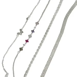 Set of 4 sterling silver chain bracelets with butterfly and flower charms for layering