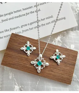 Dettaglio della parure collana e orecchini a fiore di iris in argento S925 con zirconi verdi