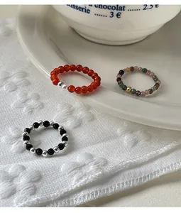 Exquisite close-up of elastic beaded rings with tourmaline, agate, and 925 silver spacers.