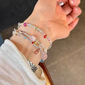 Detail of 925 sterling silver bracelets with irregular crystals and pearls on wrist