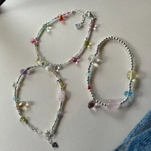 Detailed macro view of 925 sterling silver bracelets with natural crystals and pearls.